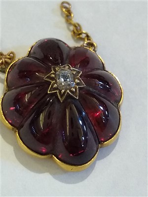 Lot 25 - A Victorian gold diamond and carved garnet lobed pendant