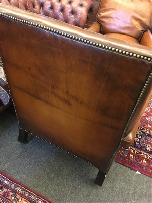 Lot 164 - A pair of brown leather armchairs