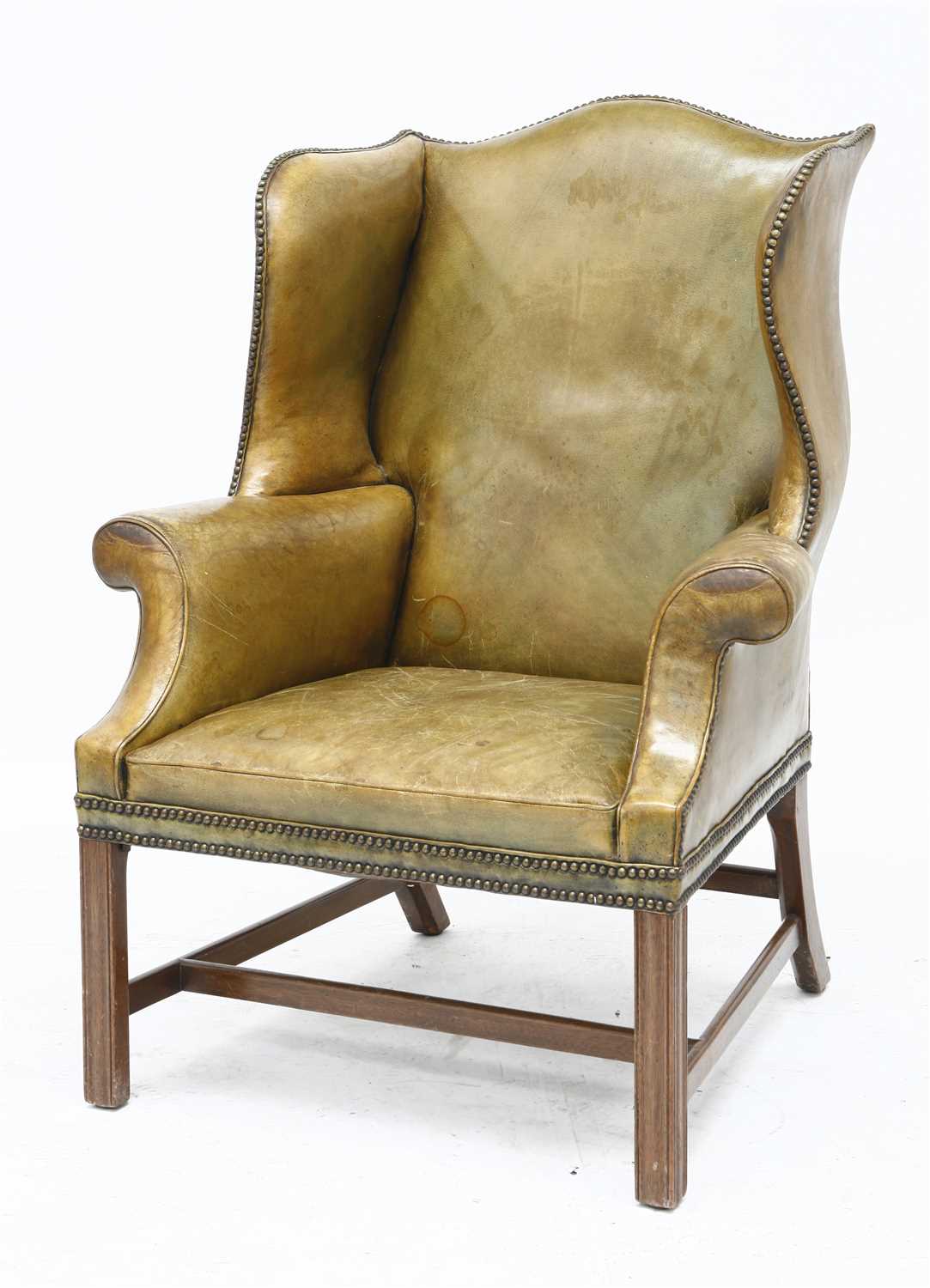 Lot 133 - A George III-style green leather wing armchair