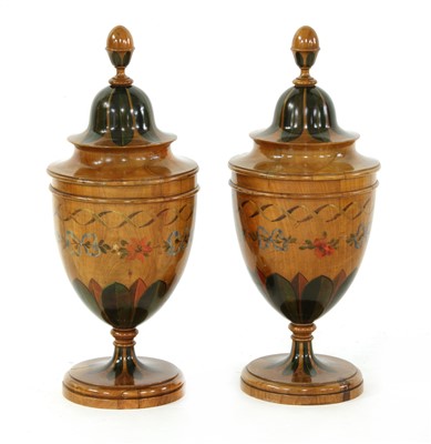 Lot 206 - A pair of painted wooden urns and covers