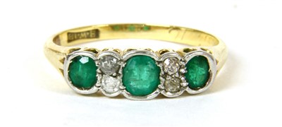 Lot 10 - A three stone emerald ring