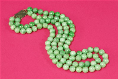 Lot 87 - A two row uniform jadeite bead necklace