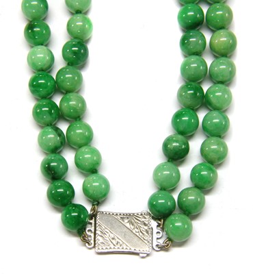 Lot 87 - A two row uniform jadeite bead necklace