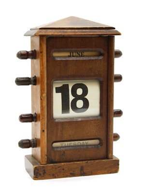 Lot 92 - A walnut cased desk calendar