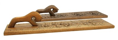 Lot 178 - A near pair of Scandinavian carved wooden mangle boards