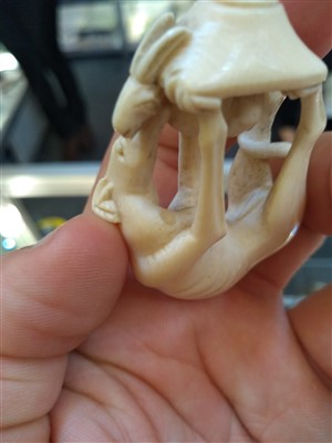 Lot 203 - A carved ivory pipe tamper