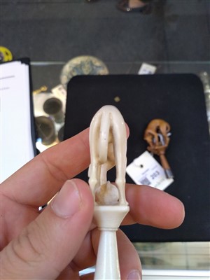 Lot 203 - A carved ivory pipe tamper