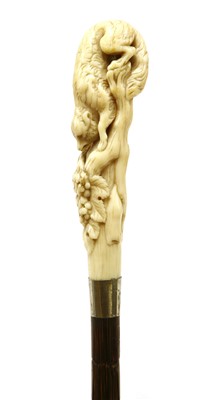Lot 151 - A carved ivory and partridgewood(?) walking stick