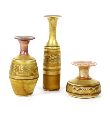 Lot 149 - Three small Persian design copper lustre vases