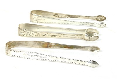 Lot 79 - Three pairs of Georgian silver sugar tongs