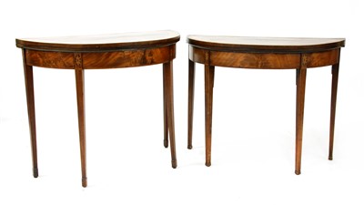 Lot 348 - A near pair of early 19th century Sheraton style inlaid mahogany fold over card tables