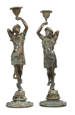 Lot 191 - A pair of bronze figural candlesticks