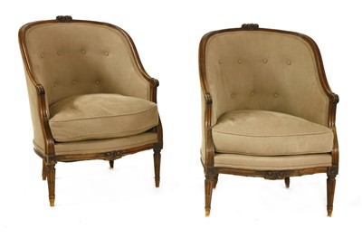 Lot 617 - A pair of French walnut fauteuil tub chairs