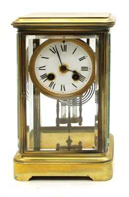 Lot 224 - A late 19th century brass and four glass mantel clock