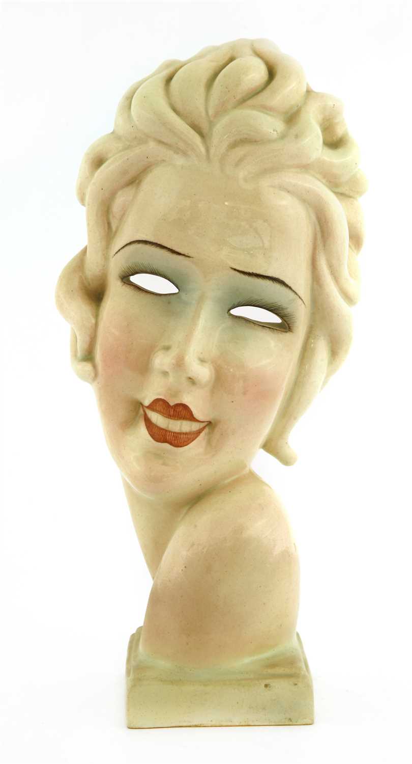 Lot 229 - An Art Deco pottery mask of a girl