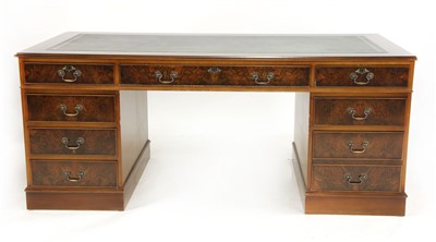 Lot 674 - A reproduction walnut twin pedestal desk