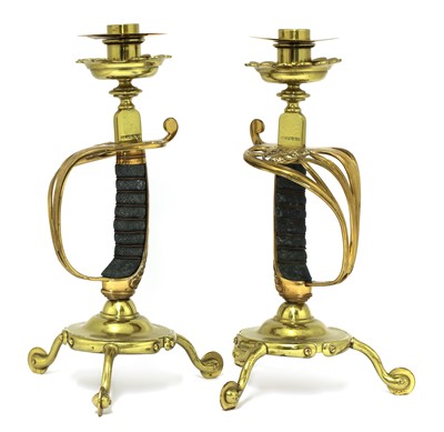 Lot 181 - A pair of brass sword hilt candlesticks