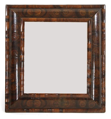 Lot 823 - An oyster-veneered walnut cushion-framed wall mirror