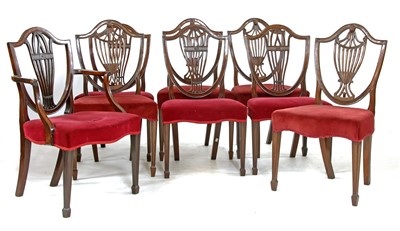 Lot 618 - A set of four George mahogany Hepplewhite style shield back chairs