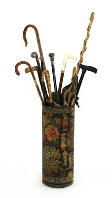Lot 412 - A tin stand wirh various walking sticks and a parasol