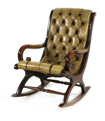 Lot 602 - A mahogany and studded leather rocking open armchair