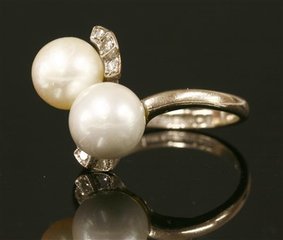 Lot 266 - An 18ct white gold cultured pearl and diamond two stone crossover ring