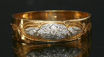 Lot 186 - A French diamond set platinum and gold hinged bangle