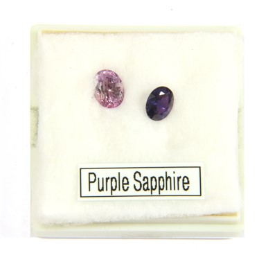 Lot 157 - Two unmounted oval mixed cut purple sapphires