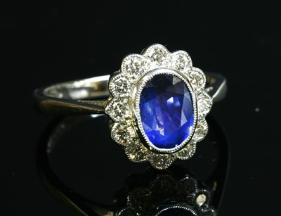 Lot 489 - A platinum sapphire and diamond cluster ring