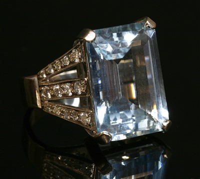 Lot 449 - An 18ct white gold single stone aquamarine ring with diamond set shoulders