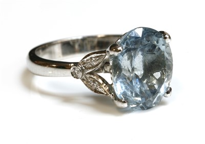 Lot 438 - An 18ct white gold single stone aquamarine ring with diamond set shoulders