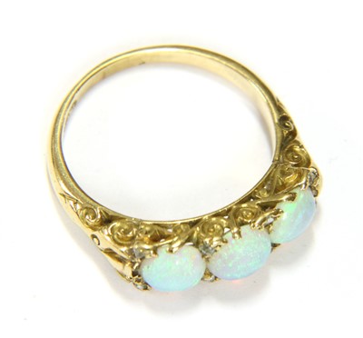 Lot 66 - A three stone opal ring