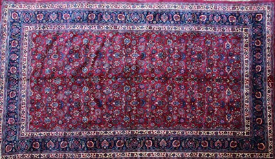 Lot 556 - A large Persian rug