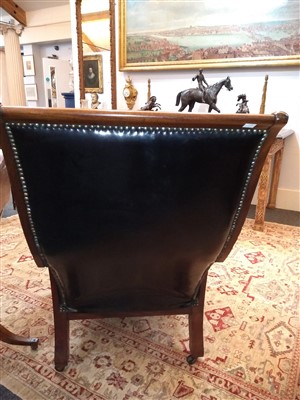 Lot 402 - A William IV mahogany and studded leather reclining library armchair
