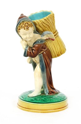 Lot 188 - A 19th Century Minton majolica spill vase in the form of a winged cherub on naturalistic base