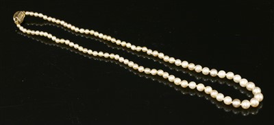 Lot 162 - A single row uniform pearl necklace with a diamond set box clasp