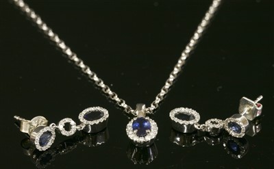 Lot 57 - A white gold, sapphire and diamond cluster pendant necklace and earring matched suite