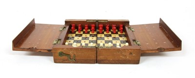 Lot 134 - A miniature travelling chess set