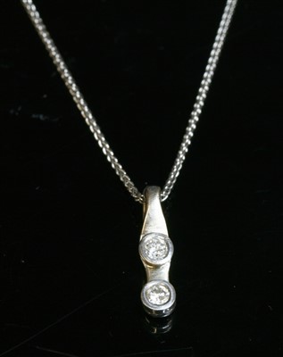Lot 482 - An 18ct white gold two stone diamond pendant