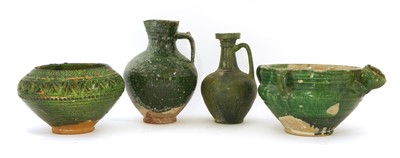 Lot 476 - Four Persian green-glazed pottery vessels