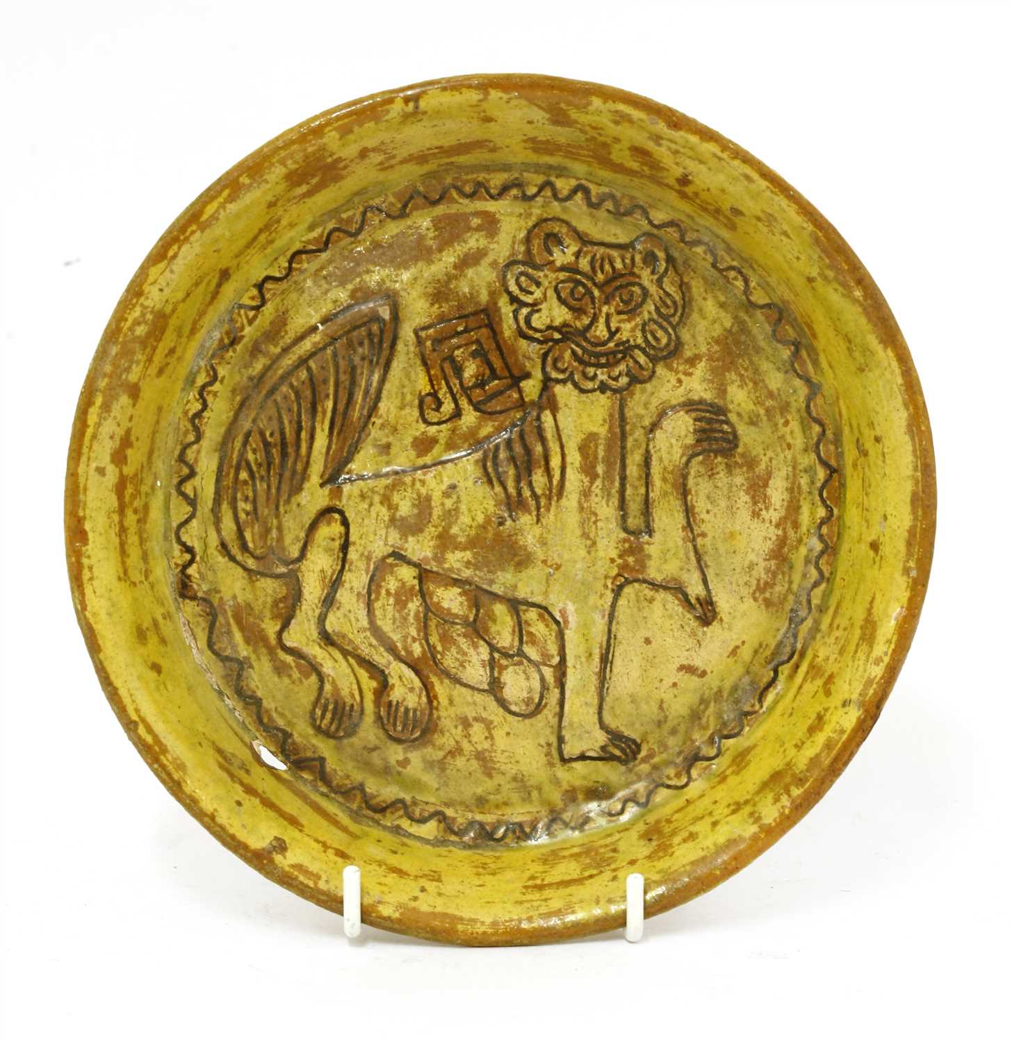 Lot 475 - A Fustat Fatimid yellow-glazed sgraffito dish