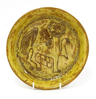 Lot 475 - A Fustat Fatimid yellow-glazed sgraffito dish
