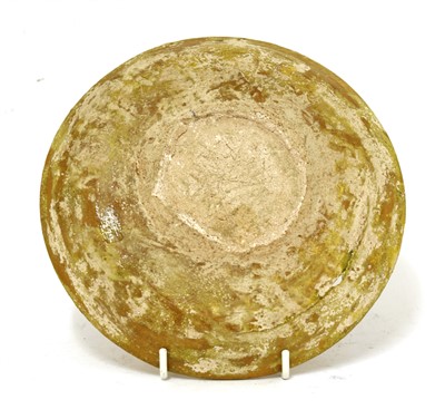 Lot 475 - A Fustat Fatimid yellow-glazed sgraffito dish