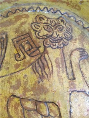 Lot 475 - A Fustat Fatimid yellow-glazed sgraffito dish