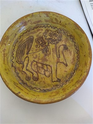 Lot 475 - A Fustat Fatimid yellow-glazed sgraffito dish