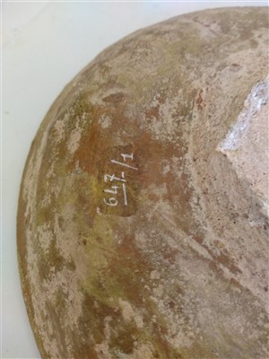 Lot 475 - A Fustat Fatimid yellow-glazed sgraffito dish
