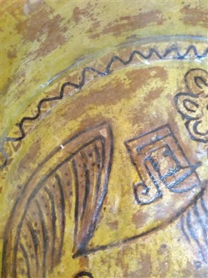 Lot 475 - A Fustat Fatimid yellow-glazed sgraffito dish