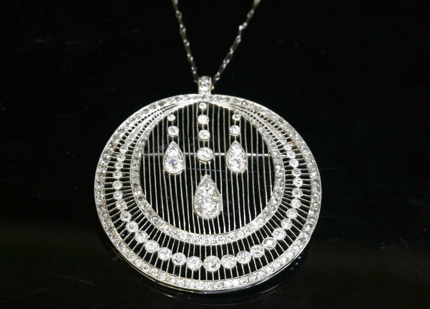 Lot 197 - A Continental Belle Époque diamond set crescent brooch/pendant, c.1915
