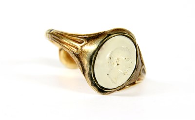 Lot 63 - A gold signet ring set with a cabochon chalcedony intaglio to the head