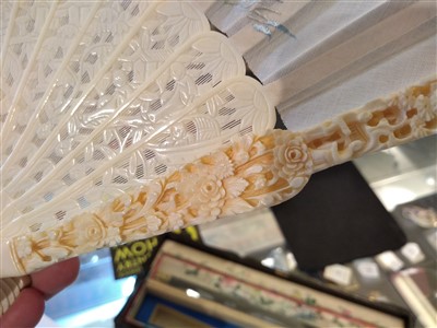 Lot 184 - A late 19th century carved ivory and silk fan